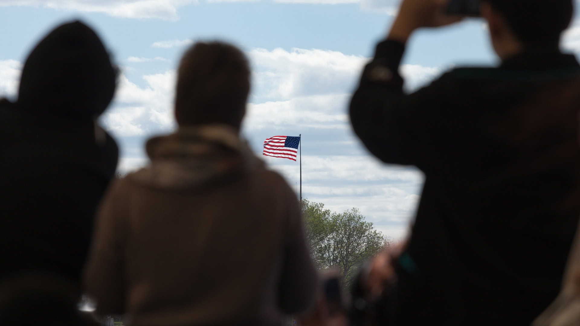 American Flag Sky Silhouetted People